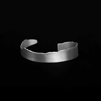 Torn Bangle by Laura Nelson - contemporary silver jewellery exploring processes. Designed and made in the UK.